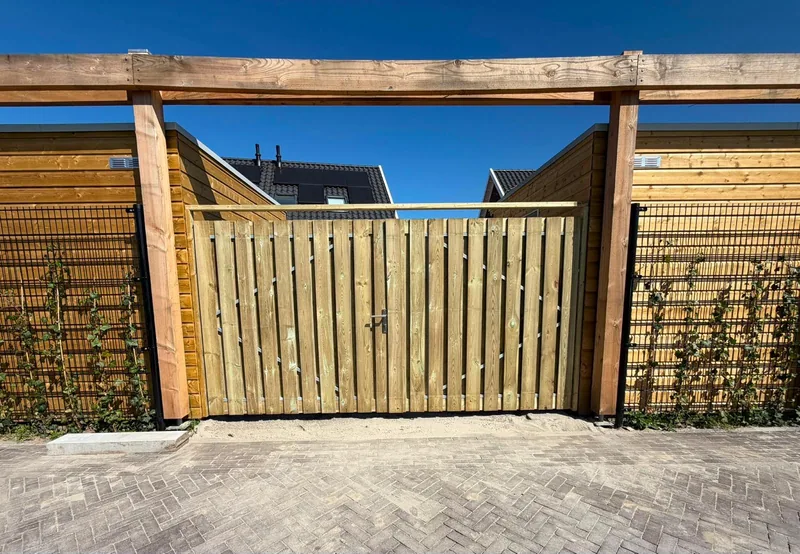 Hardwood garden gate between two fences